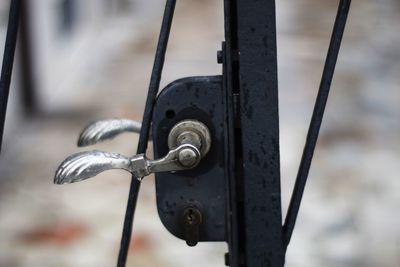 Close-up of keyhole on metallic gate