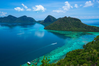 High angle view of sea and mountains against sky