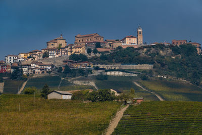 Buildings in city against clear sky