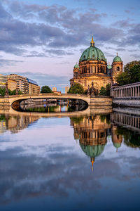 The berlin cathedral after sunset with a reflection in the river spree