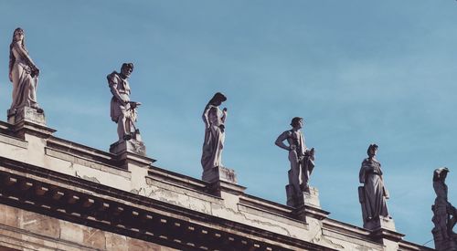 Low angle view of statues against sky