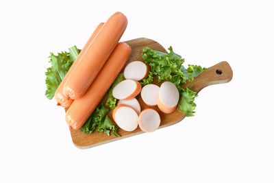 High angle view of vegetables on cutting board against white background
