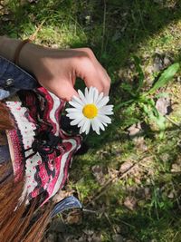 Close-up of woman hand with flowers