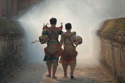 Rear view of people walking on water