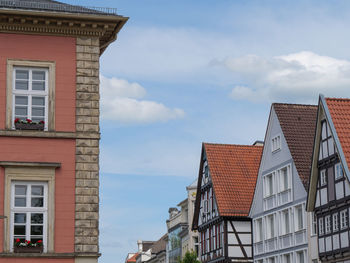 Low angle view of buildings against cloudy sky