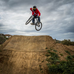 Low angle view of man jumping while doing bmx cycling