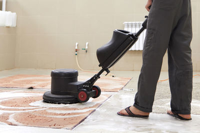 Low section of man working on floor