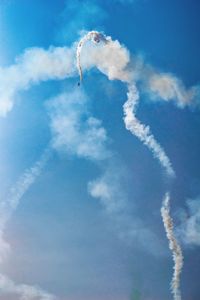 Low angle view of airplane flying against blue sky