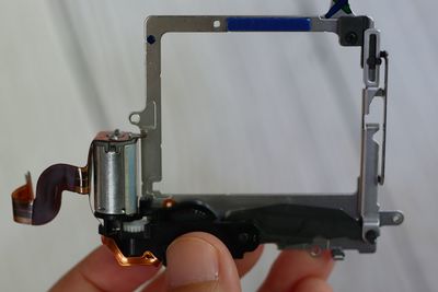 Cropped hand of man repairing machine part