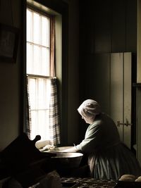 Woman sitting in window