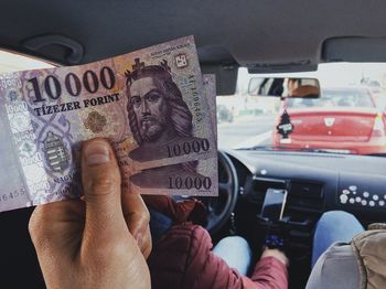 Midsection of men sitting in car