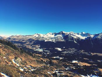 Scenic view of mountains against clear blue sky