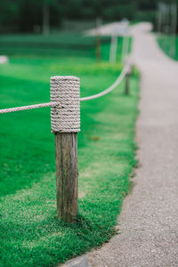 Close-up of wooden post on field