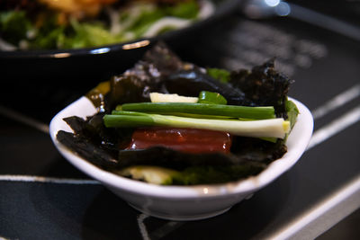 High angle view of half-dried herring slice and vegetables in bowl on table