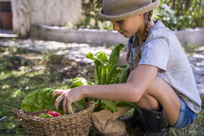 Girl keeping vegetables in basket