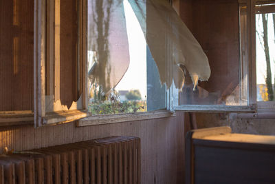 Clothes hanging on table by window at home