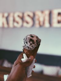 Close-up of hand holding ice cream cone