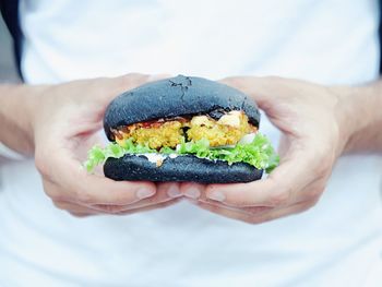 Close-up of person holding burger