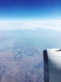 Aerial view of landscape against blue sky