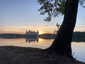 Scenic view of lake against sky during sunset