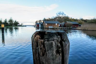 Built structure by lake against sky