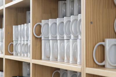 Close-up of empty cups in row