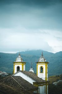 Church by building against sky