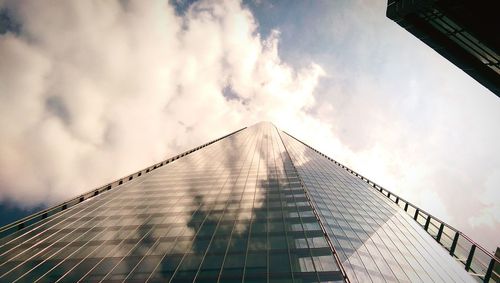 Low angle view of building against cloudy sky