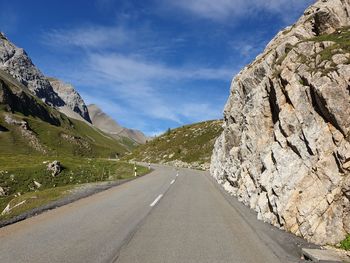 Road amidst mountains against sky