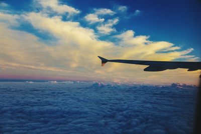 Airplane flying over sea against sky