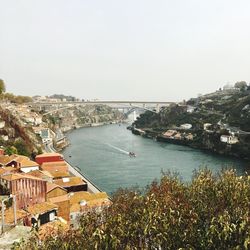 High angle view of town by sea against clear sky