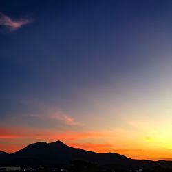 Scenic view of silhouette mountains against sky during sunset