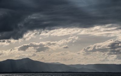 Scenic view of clouds over mountains against sky