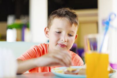 Portrait of cute boy looking at home