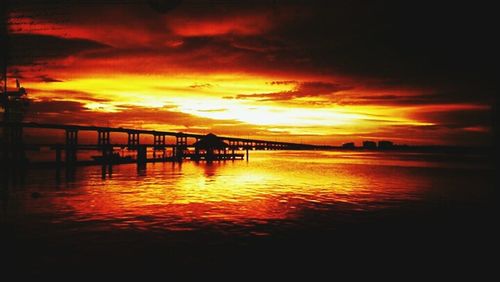 Silhouette of pier at sunset