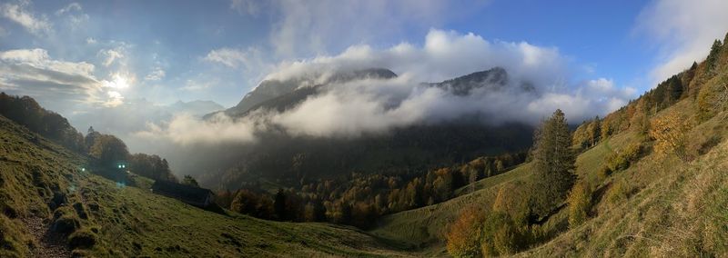 Panoramic view of trees and mountains against sky