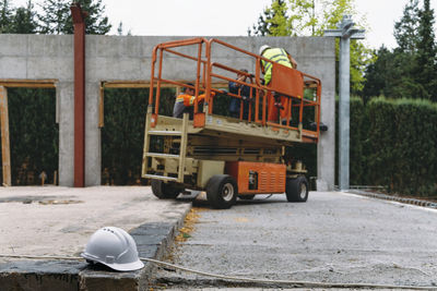 Scissor lift platform on a construction site. building concreate house with mobile transportation