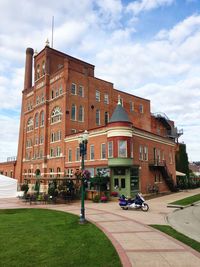 Building by street against sky in city