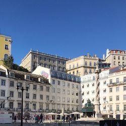 View of buildings against blue sky