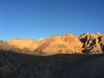 Scenic view of mountains against clear blue sky