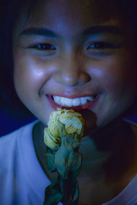 Close-up portrait of young woman eating food