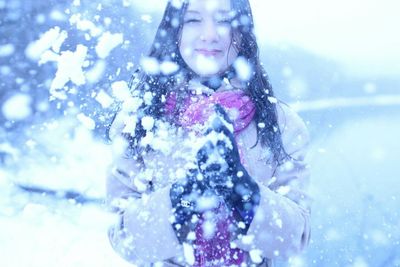 Portrait of smiling young woman during winter