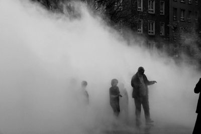People standing by water