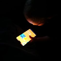 Close-up of boy holding mobile phone