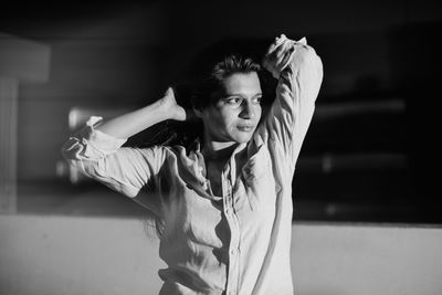 Close-up of woman looking away sitting in darkroom