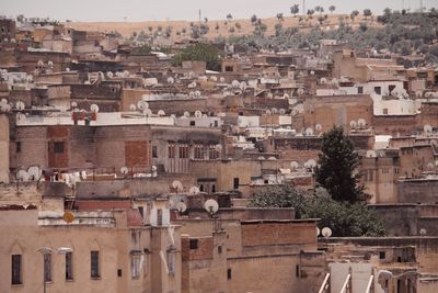 High angle view of buildings in city with satellite dishes