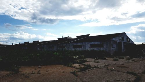 Built structure on landscape against sky