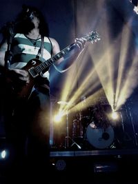 Man playing guitar at music concert