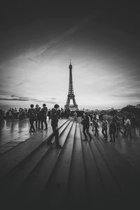 People at steps against eiffel tower