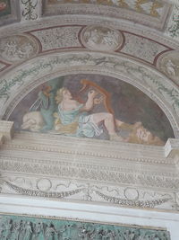 Low angle view of carvings on ceiling